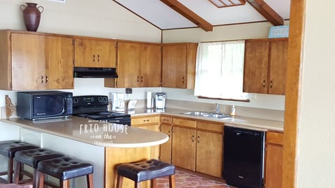A modern kitchen that is fully stocked with utensils, cook ware, and more.