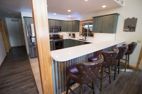 Rustic modern new remodeled kitchen and four person bar.