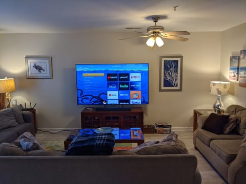 Living room with 75" TV and Roku soundbar.