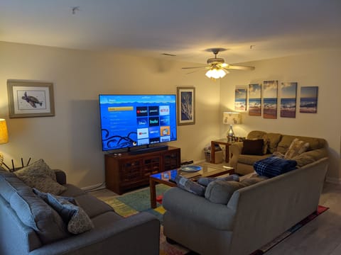 Living room with 75" TV and Roku soundbar.