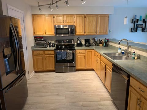 Kitchen w/ brand new premium dark stainless appliances and flooring