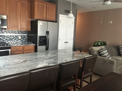 Beautiful Granite & Tiled Backsplash open concept to living area