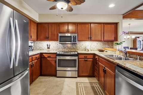 Kitchen, well stocked with dishes, pots and pans for in home dining.
