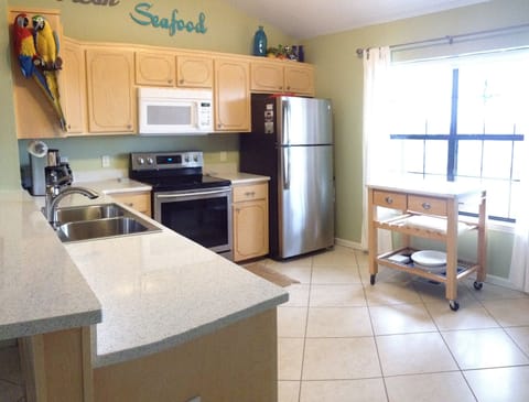 Stainless appliances and quartz countertops. Cart adds even more prep space 