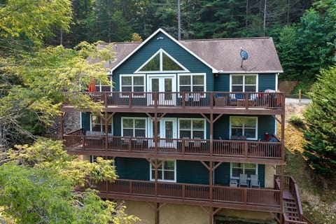 View of the Back of the house from lake side. 3 full decks. 2 grills. Hot Tub.