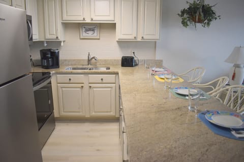 The kitchen with bar is the perfect place to enjoy food, family and friends.