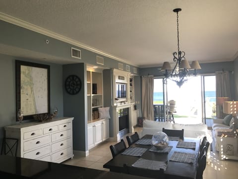 Blue-gray living and dining area with fireplace, perfect for entertaining.