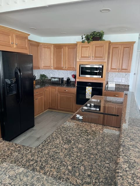 Spacious open kitchen with JennAir stove, bluetooth oven, granite counter tops.