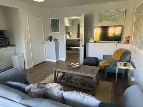 Cozy sitting room. Kitchenette to the left and bedroom through doorway.