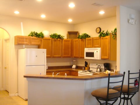 Large open kitchen with cooking ware and utensils.