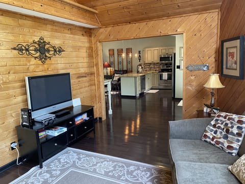 Living room. Large screen tv. Lots of games, puzzles, cards, toys, etc.