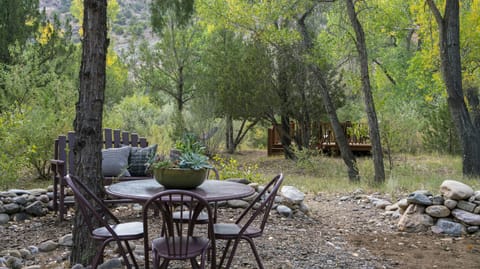 Eating area in back on the river side. Deck in the background.