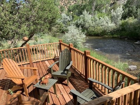 Relaxing deck overlooking the Embudo River with seating for four.