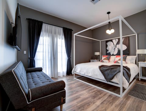 1 of our 6 adult bedrooms... en-suite King master with a futon and 55" smart TV