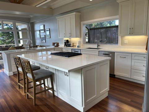 Kitchen has 2 sinks and 2 dishwashers