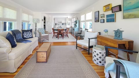 Bright and comfortable family room with dining area and kitchen beyond