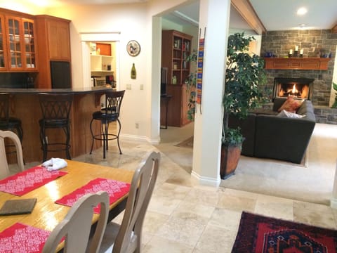 Travertine stone dining area seats 6, cherry and porcelain raised bar seats 3