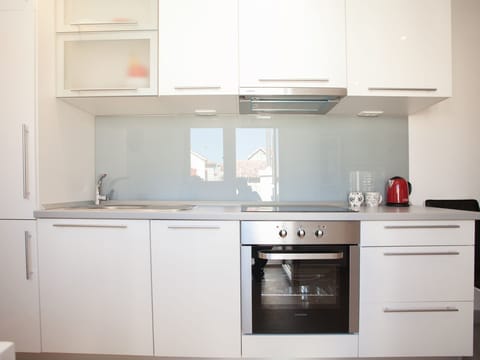Fully equipped kitchen with dishwasher, stove top and oven.