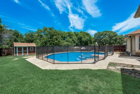 large private backyard with safety gate on pool