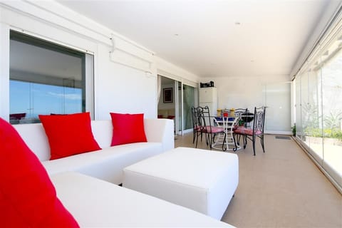 Another view of the covered terrace with relaxing seating and dining area