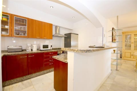 Open kitchen in this apartment is fully fitted with all the appliances