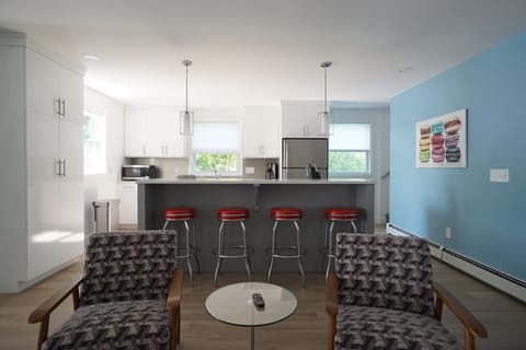 Brand new kitchen with a cooking island and stools.