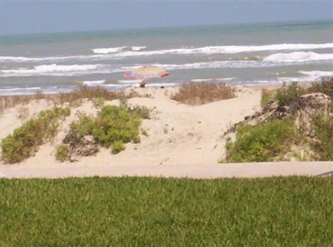 View of the beach and ocean from the condo's connected private patio.