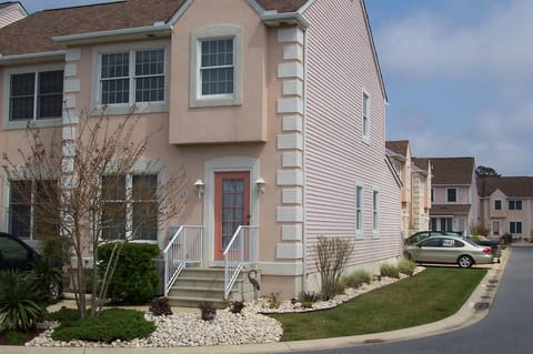Front of building, showing the side of the unit and the sun room in the back.