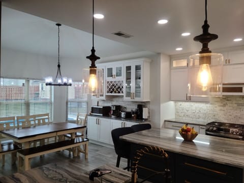 Newly renovated kitchen with seating for 8 at table, 2 at island, and 3 at bar.