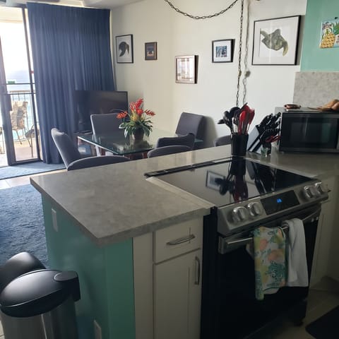 View from kitchen looking into living room with curtains open.