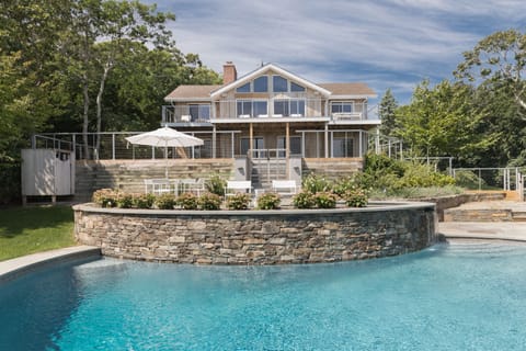 Gorgeous moon shaped pool with waterfall spa
