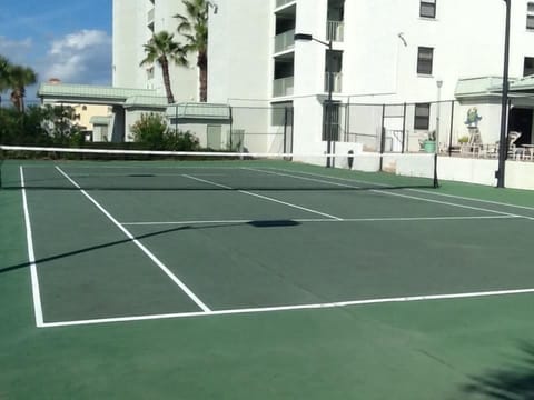 A single tennis court on the premises.