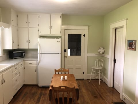 Spacious kitchen with refrigerator, oven, microwave, toaster, table & much more