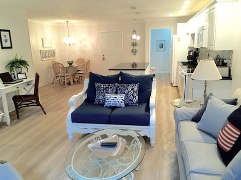 View of open floor plan from the sliding door back to kitchen and dining area.