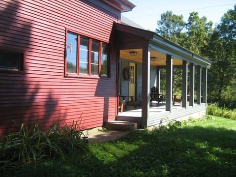 Porch with dining table and Adirondack chairs