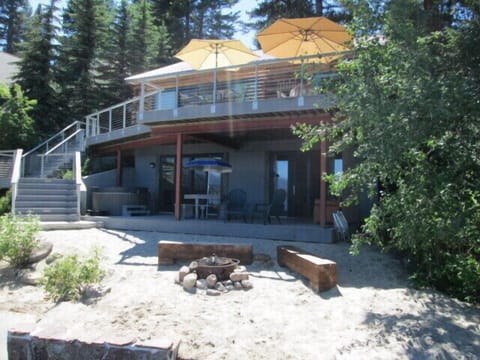 Lakefront view of house, upper & lower decks, sandy beach, firepit, hot tub