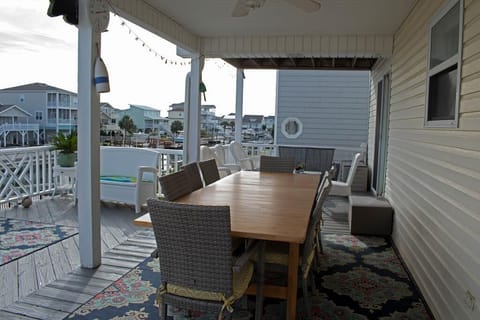 rear open deck with large outside table for open air dining watching boats on by