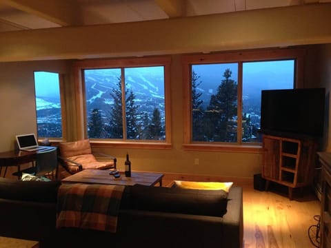 Enjoy a warm living room on the top floor with expansive views of Breckenridge.