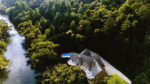 Grand Estate on the Toccoa River! The estate has an amazing yard for games, a pool, hot tub, a play structure, movie theater, bar, and games!