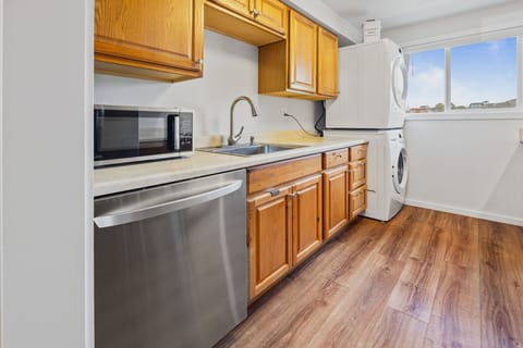 Stack washer/dryer available in the kitchen.