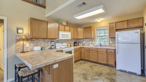Kitchen with stove, oven, microwave, refrigerator, and freezer