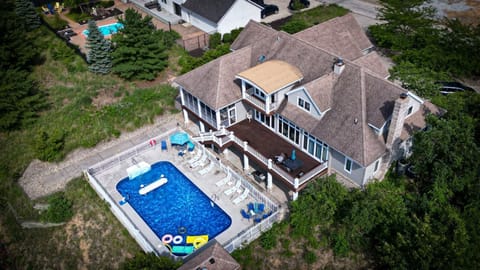 Aerial view of back of house (pool, shuffle board court, deck)