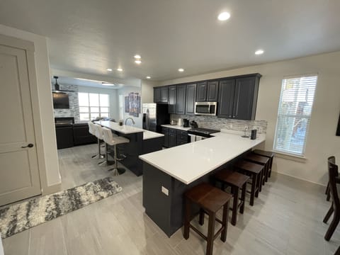 PHOTO TAKEN FROM FRONT ENTRY DOOR INTO KITCHEN AND DINING ROOM AREA