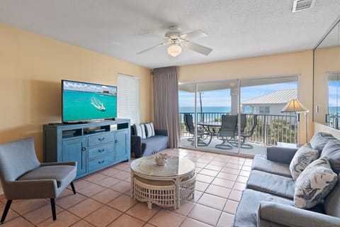 Relax on the sofa with the Gulf framed by the windows.