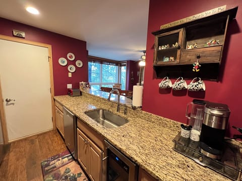Roomy kitchen with many cooking utensils, serving dishes, and even spices!