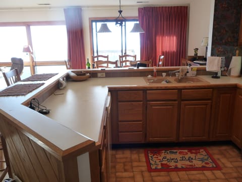 Kitchen view into dining area & deck