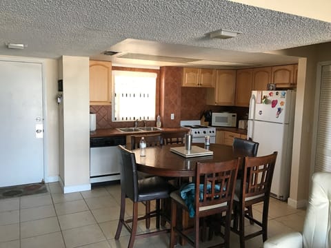 Kitchen table with six chairs, old pic shows old floors