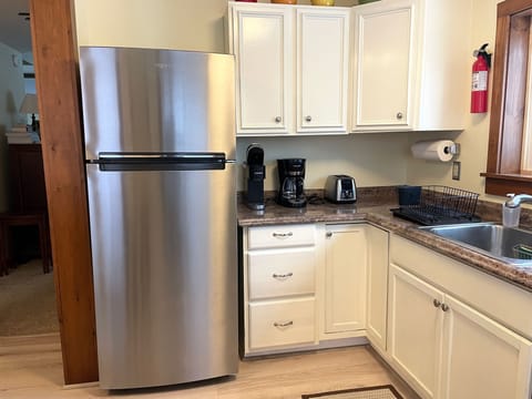 Stainless fridge, coffee maker, toaster.