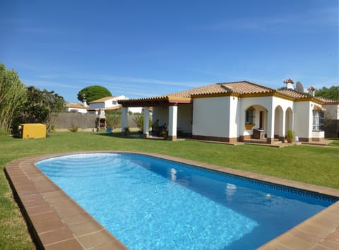 Villa with view of private pool and wrap around garden.