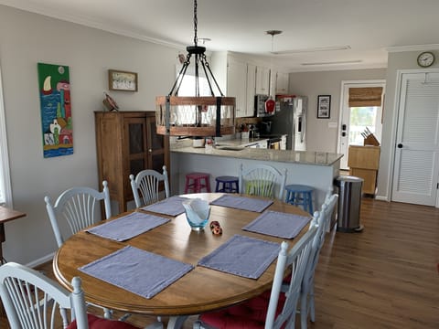 Large dining table with chairs for 6 + 4 additional seats at the bar